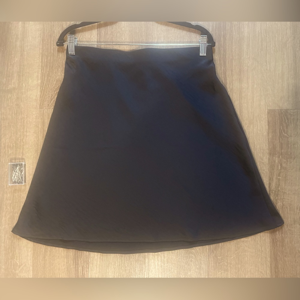 NWT Loft black satin skirt. Never worn. Hidden elastic waistband. Soft fabric.